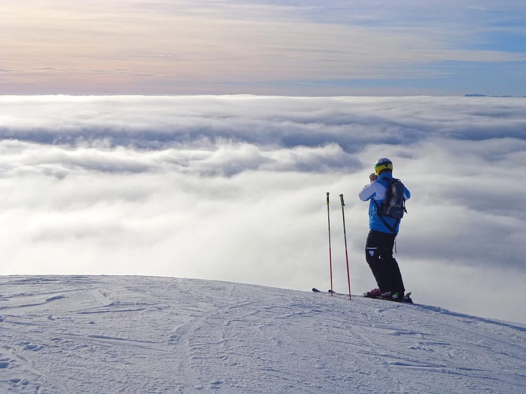 skier on top of snow covered mountain