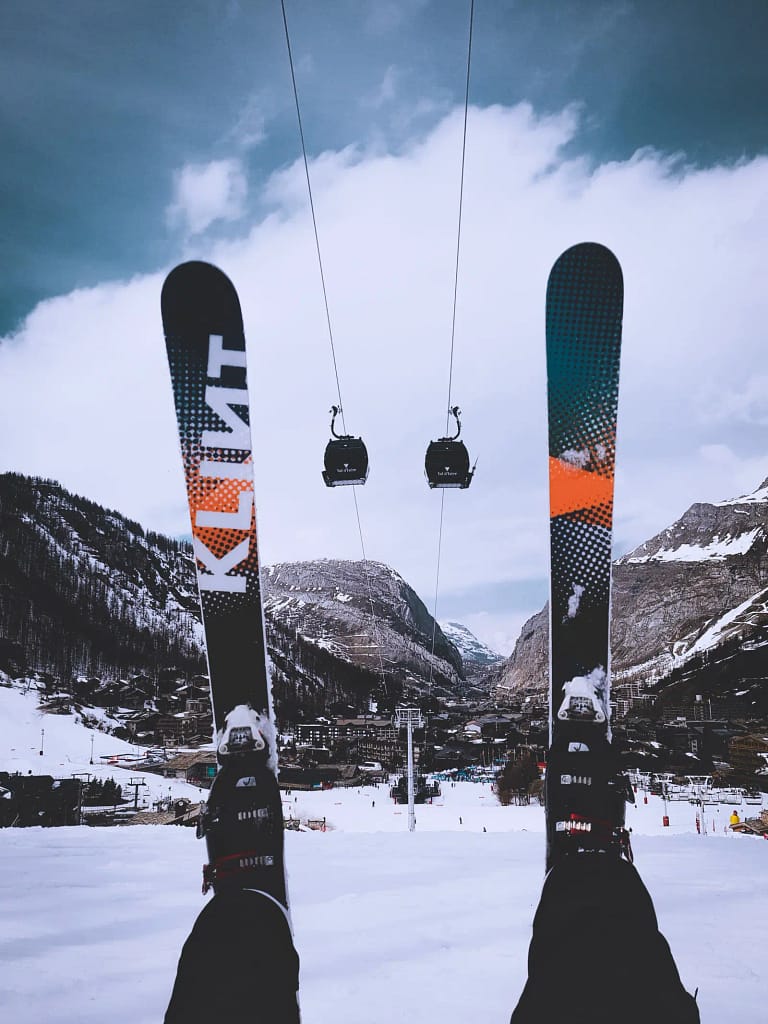 skis and ski bindings held up in air