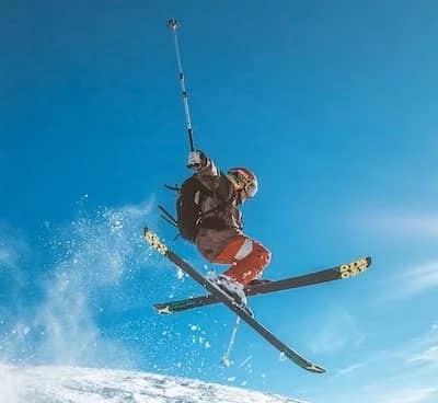 freestyle skier doing x blade trick on skis